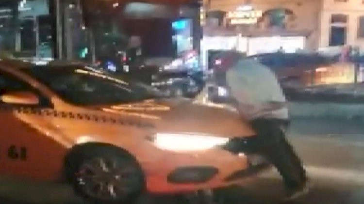 Alınmadığı taksinin üstüne çıkarak tepki gösterdi